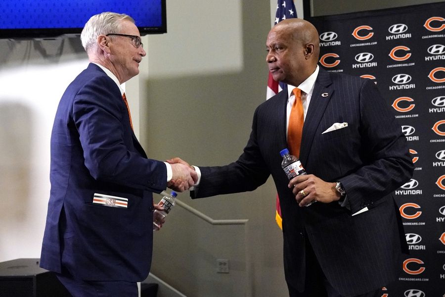 Chicago Bears Chairman George H. McCaskey, left, shakes hands with new President & CEO Kevin Warren during a news conference Tuesday at Halas Hall in Lake Forest.